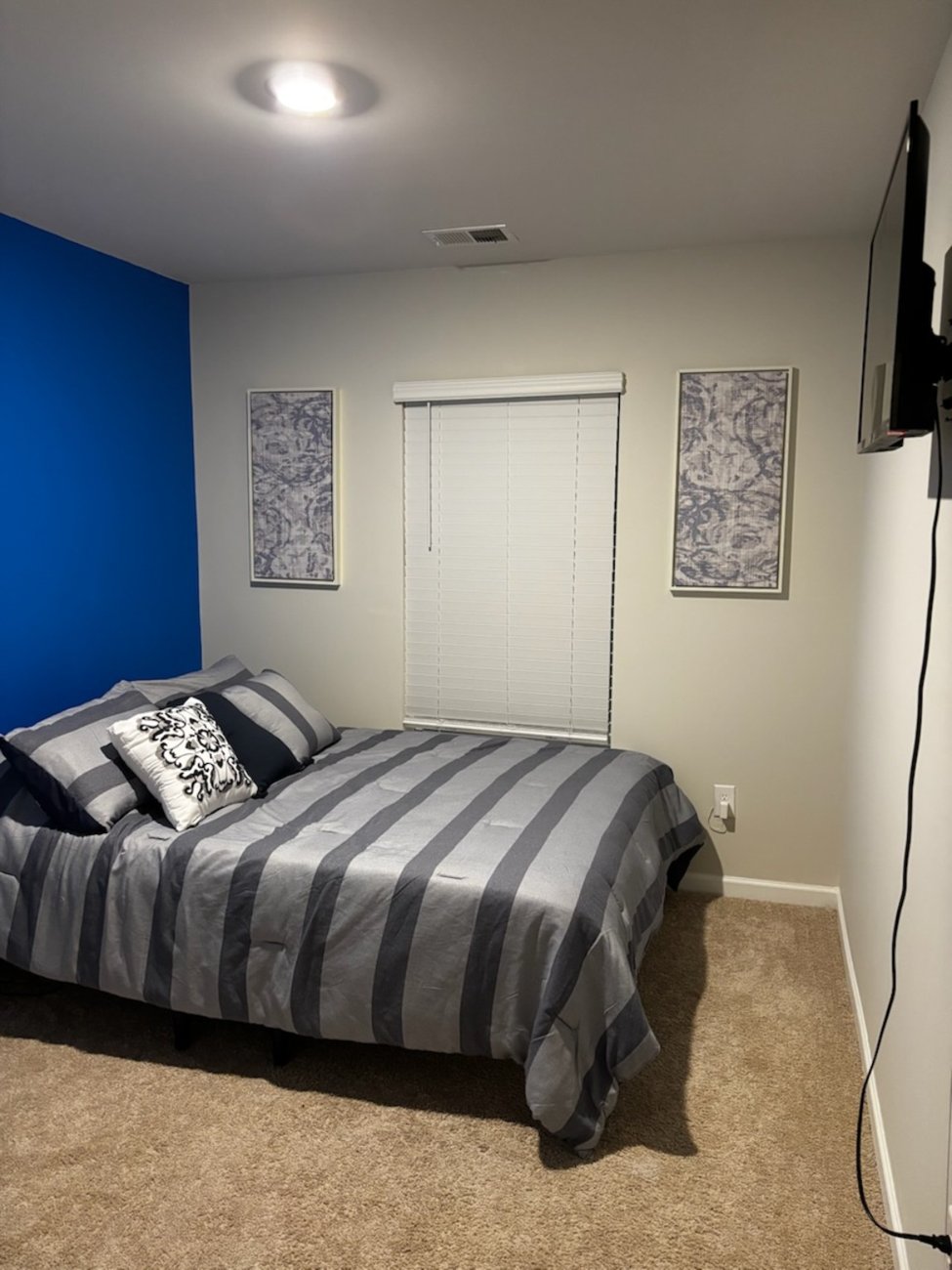 Guest bedroom with a made bed