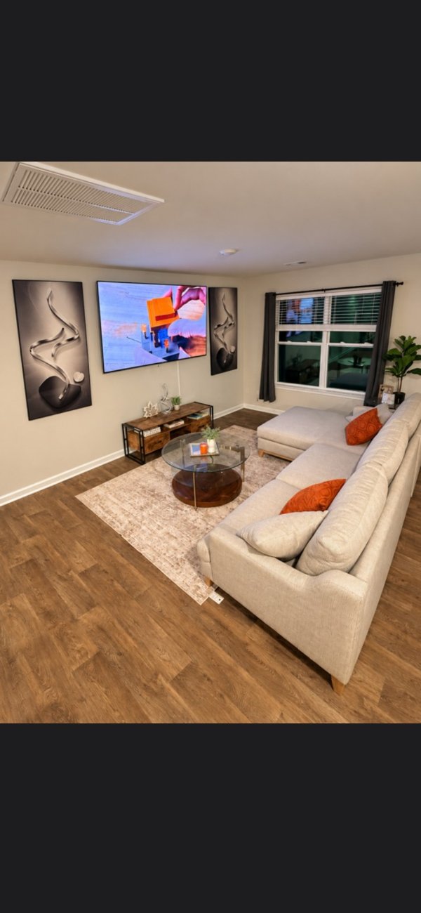 Living room with sectional sofa and large television